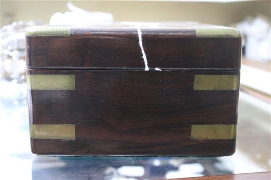 A Victorian brass mounted rosewood toilet box, containing four silver mounted bottles and four nail implements, box 28cm.